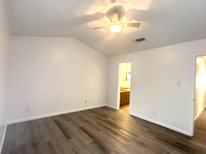 4202 Duval Road, Unit C Austin, TX 78759 - Photo 6 of 8 a view of an empty room with wooden floor and a window