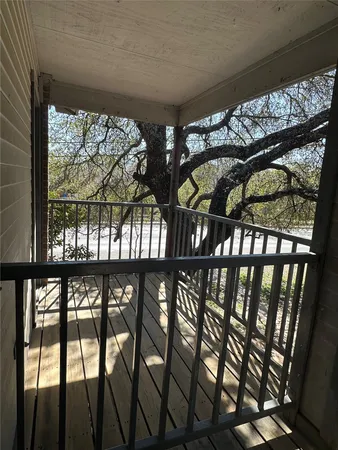 a view of a porch with a table and chairs