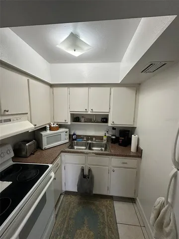 a kitchen that has a sink and a stove