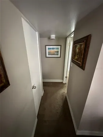 a bed sitting in a bedroom next to a window with tv