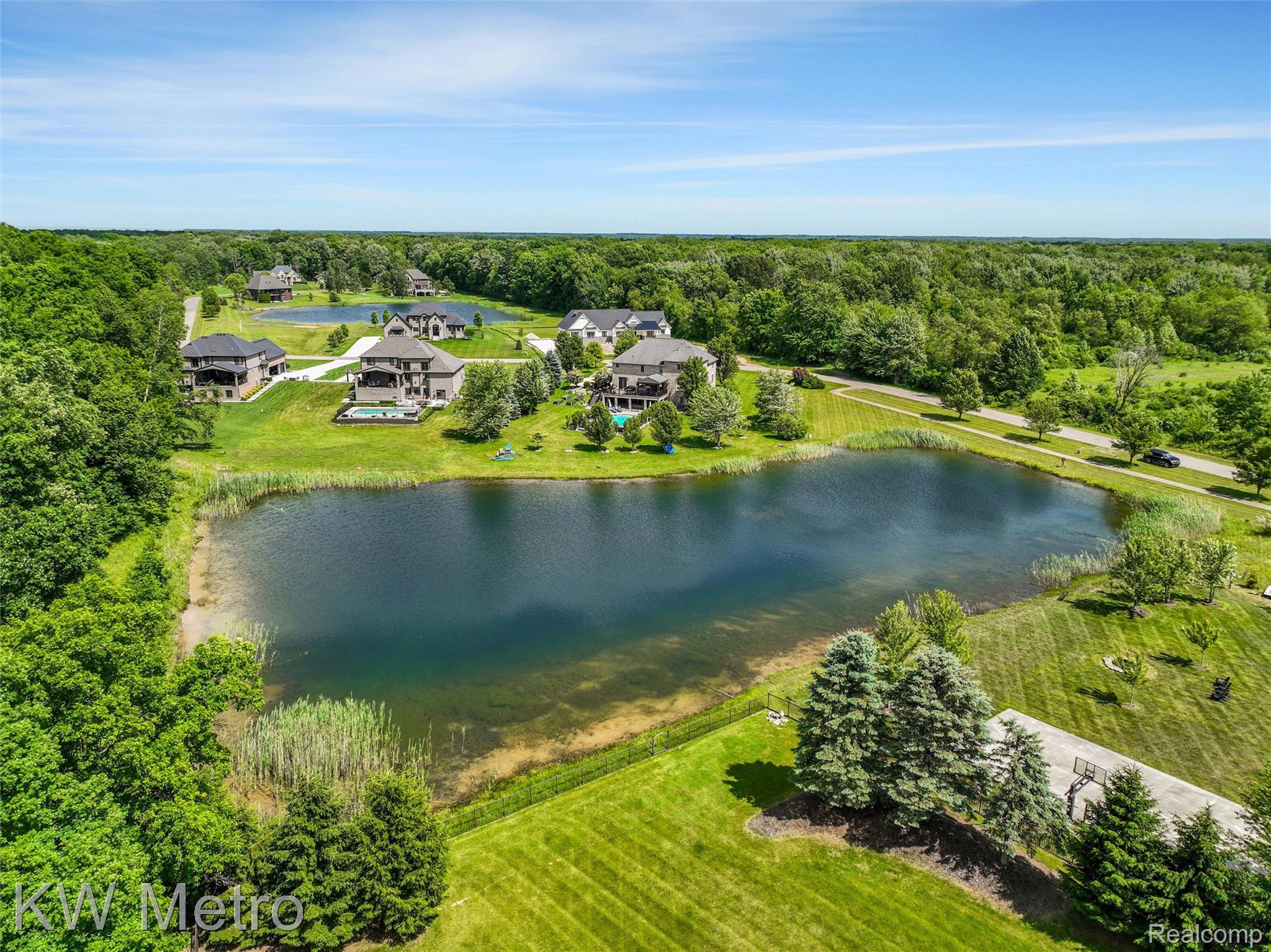 65884 Windrose Court Ray, MI 48096 - Photo 15 of 82 Expansive pond with lush green surroundings and established trees