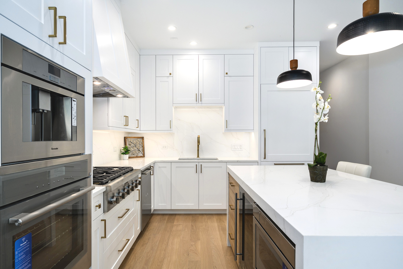 867 North Marshfield Avenue, Unit 2 Chicago, IL 60622 - Photo 6 of 19 a kitchen with granite countertop a sink stainless steel appliances and white cabinets