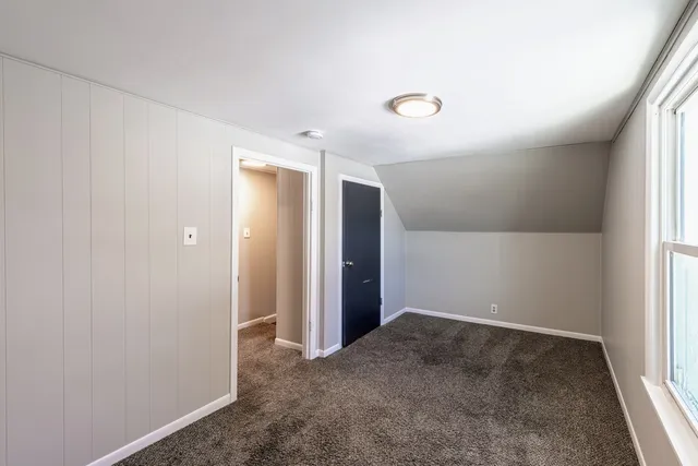 an empty room with closet and a window