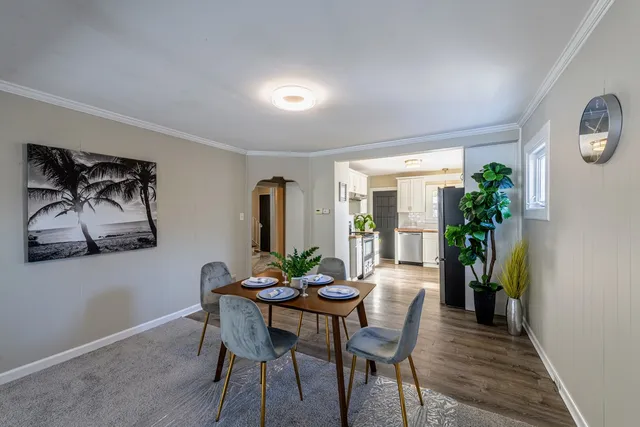 a view of a dining room with furniture and a potted plant