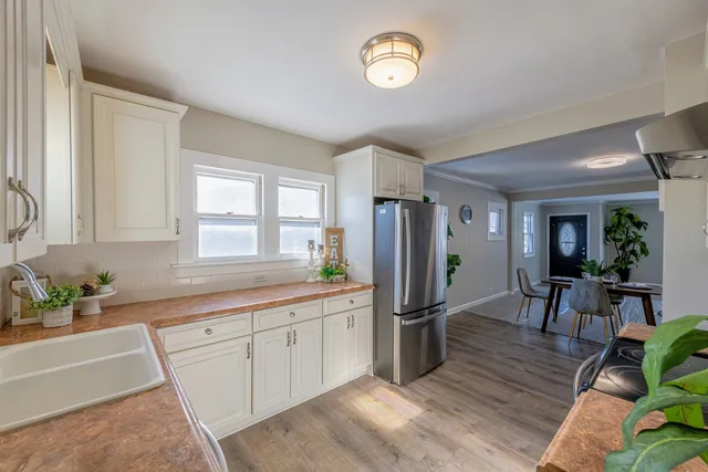 a kitchen with stainless steel appliances granite countertop a refrigerator and a stove top oven