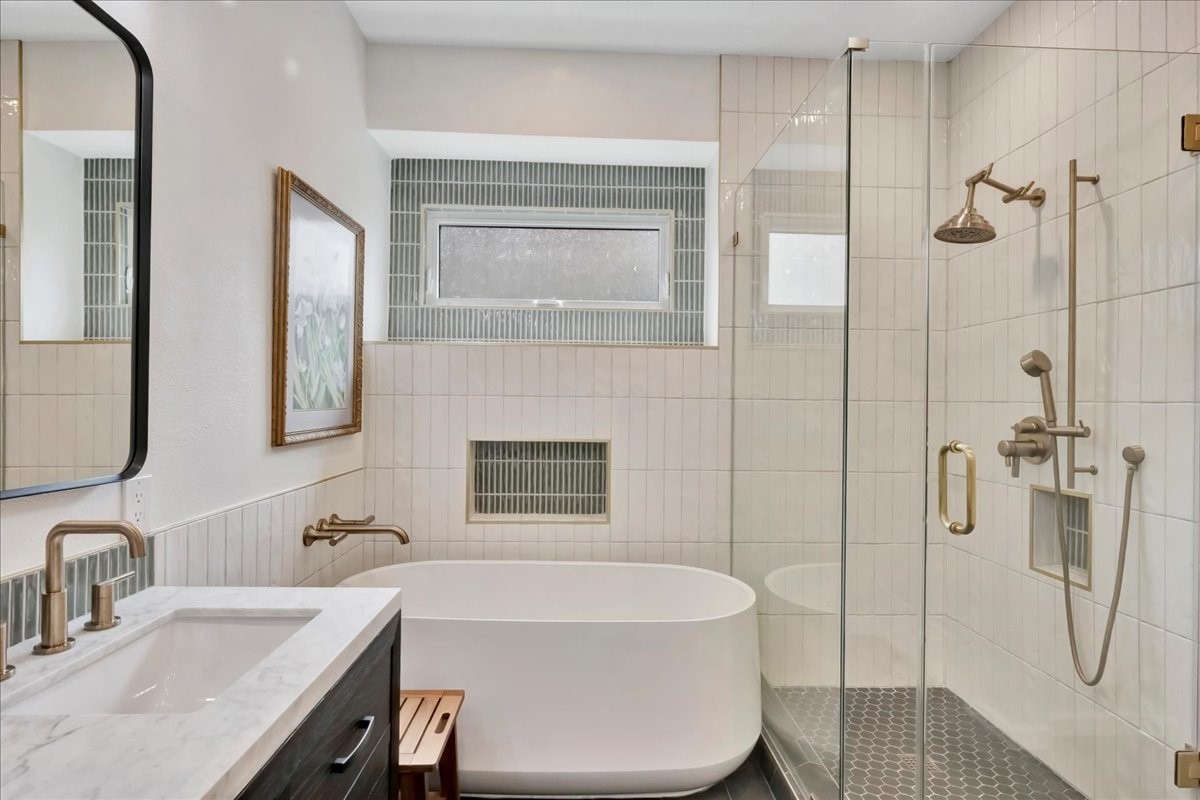 14010 Hazel Ridge Court Houston, TX 77062 - Photo 21 of 38 Primary suite remodel includes: Kohler soaking tub, Crate & Barrel vanity, Italian glass tiles + window, automatic moisture-control vent