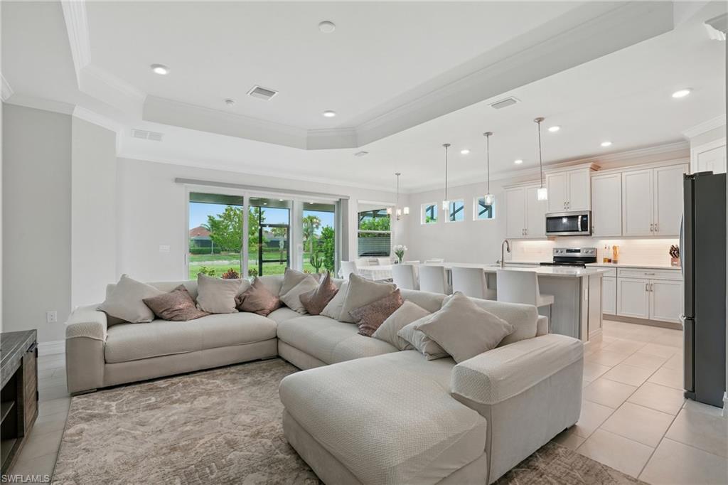 28165 Captiva Shell Loop Bonita Springs, FL 34135 - Photo 37 of 38 Kitchen with dishwasher, open floor plan, light tile patterned flooring, light stone counters, and pendant lighting
