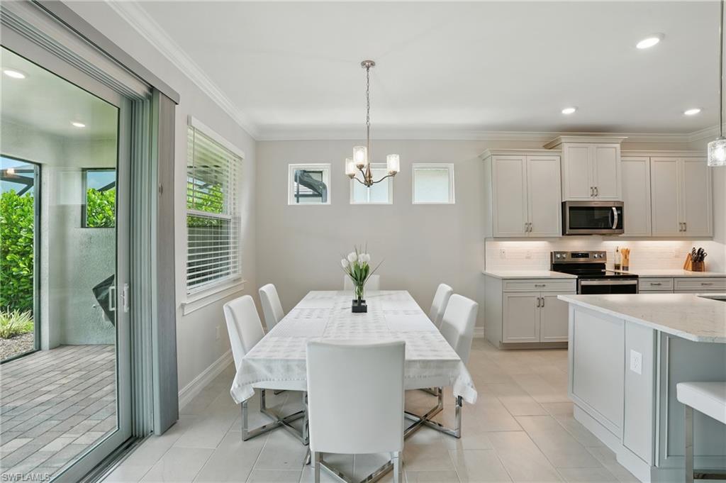 28165 Captiva Shell Loop Bonita Springs, FL 34135 - Photo 16 of 38 Bedroom featuring a tray ceiling, crown molding, and carpet flooring