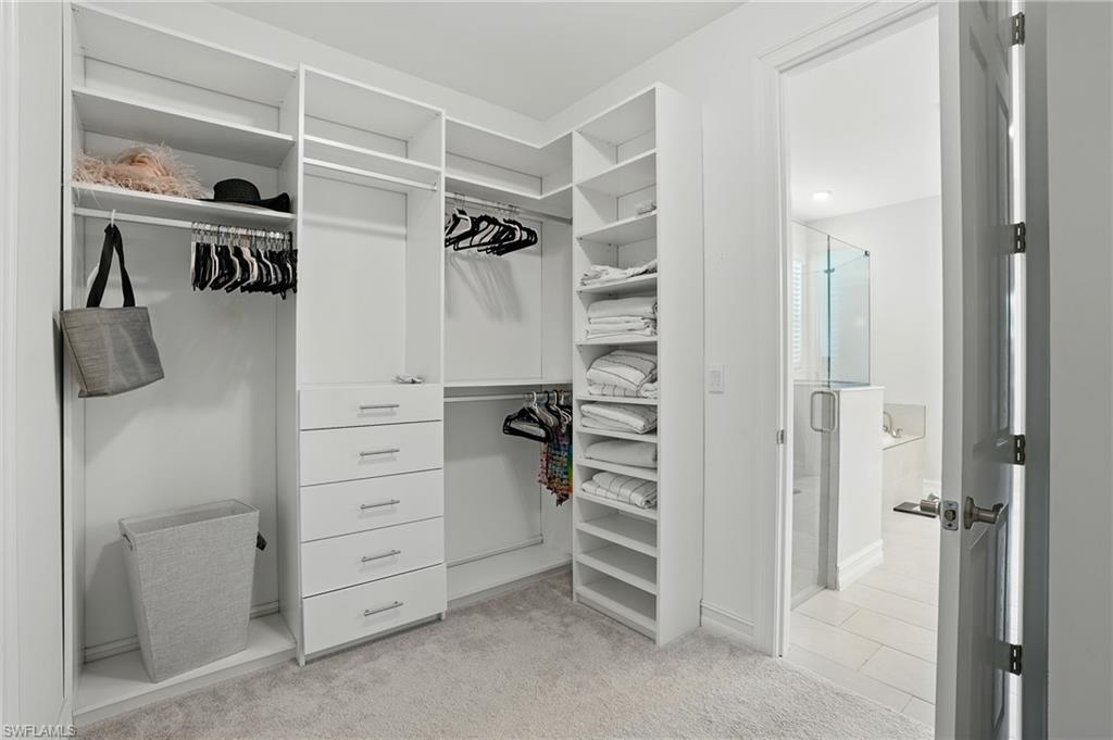 28165 Captiva Shell Loop Bonita Springs, FL 34135 - Photo 23 of 38 Bedroom with crown molding, a tray ceiling, and tile patterned flooring