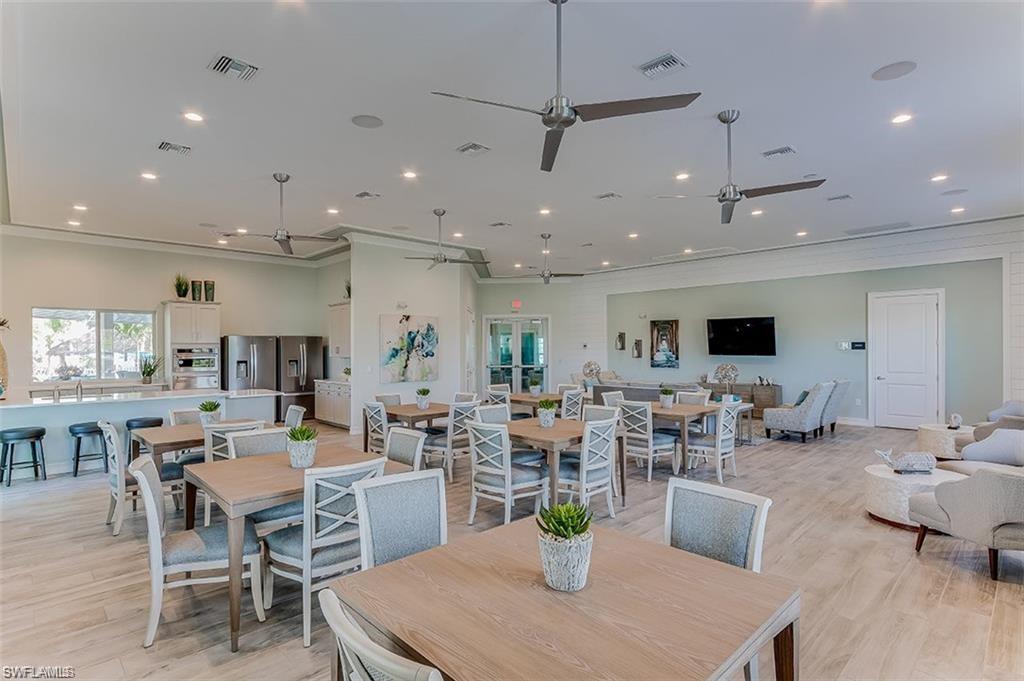 28165 Captiva Shell Loop Bonita Springs, FL 34135 - Photo 35 of 38 Dining space featuring a ceiling fan, recessed lighting, light wood-style floors, and crown molding