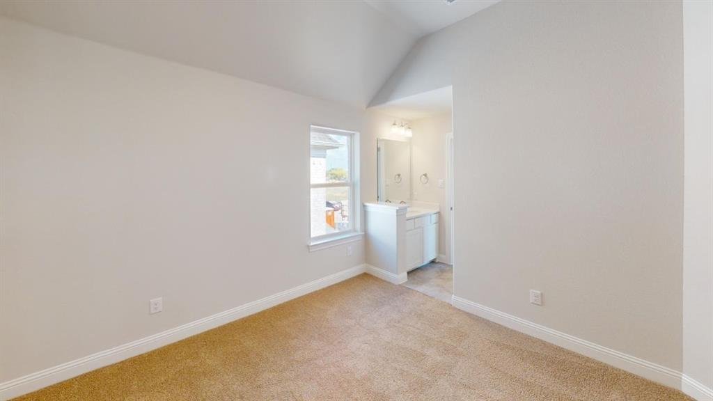 8407 Cornerstone Drive Rowlett, TX 75088 - Photo 16 of 25 Carpeted room featuring a single window and vaulted ceiling