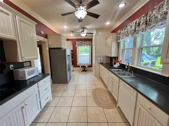 a kitchen with a refrigerator a sink and cabinets