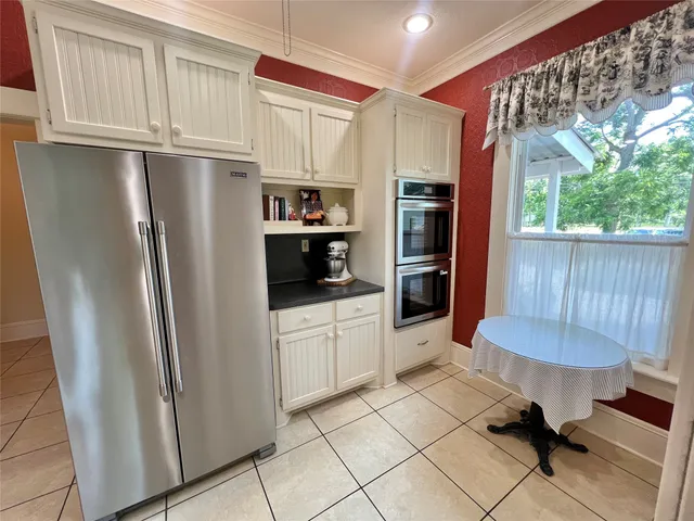 a kitchen with stainless steel appliances a refrigerator sink and cabinets