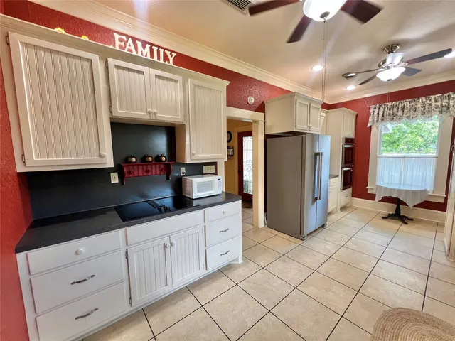 a kitchen with refrigerator and cabinets