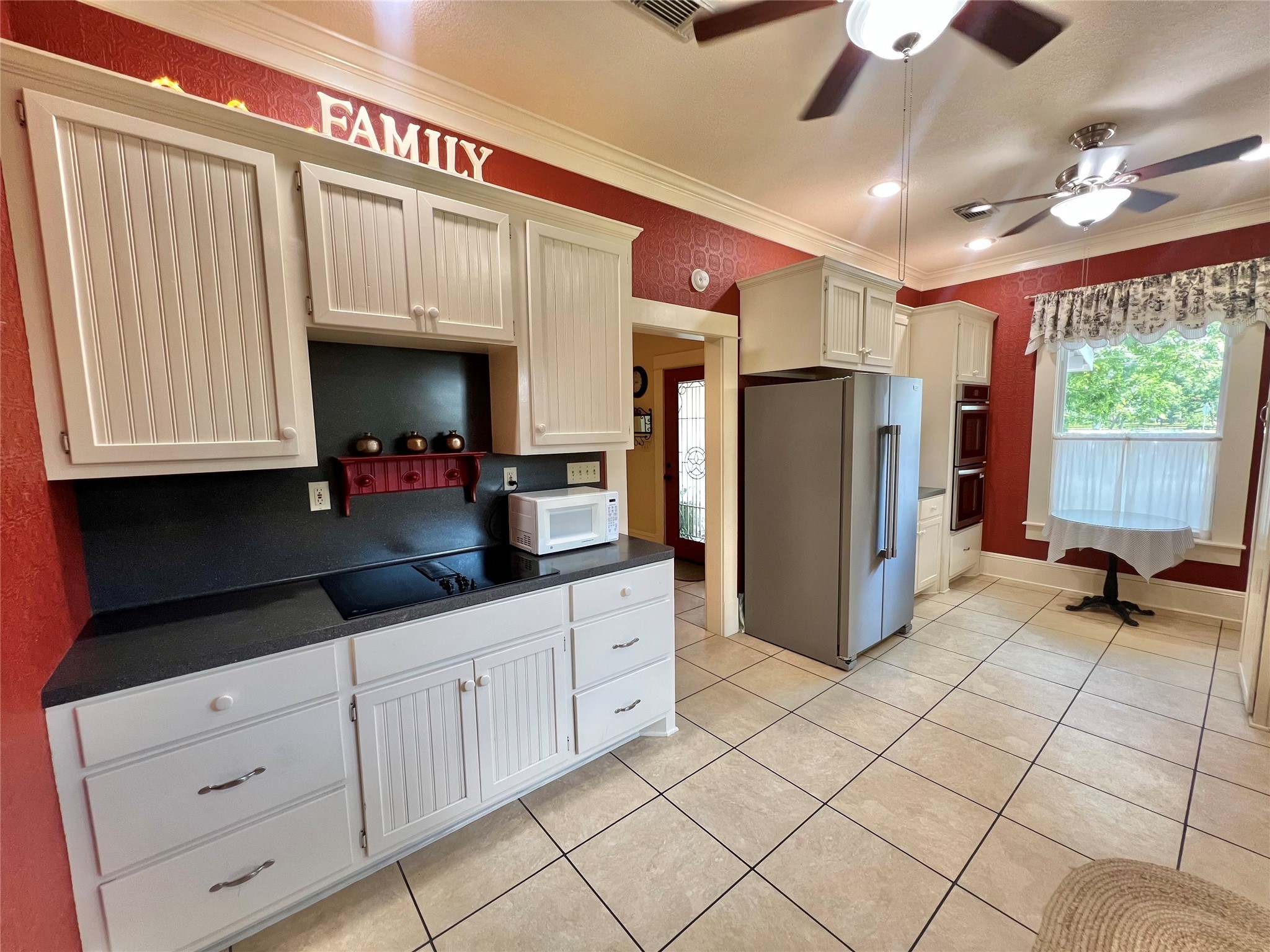 560 Jimmy Phillips Boulevard Angleton, TX 77515 - Photo 17 of 38 a kitchen with refrigerator and cabinets