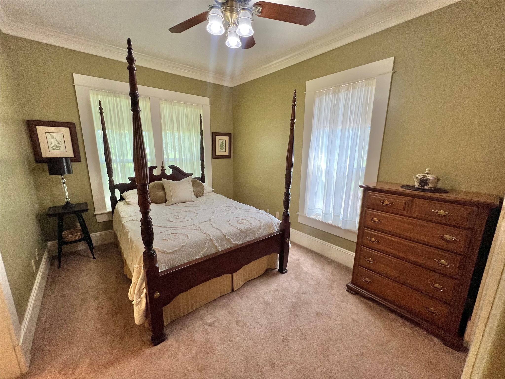 560 Jimmy Phillips Boulevard Angleton, TX 77515 - Photo 20 of 38 a bedroom with a bed and a chandelier
