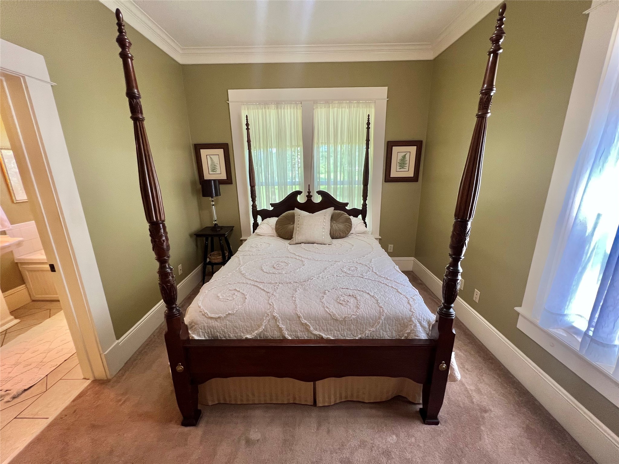 560 Jimmy Phillips Boulevard Angleton, TX 77515 - Photo 21 of 38 a bed sitting in a bedroom next to a window