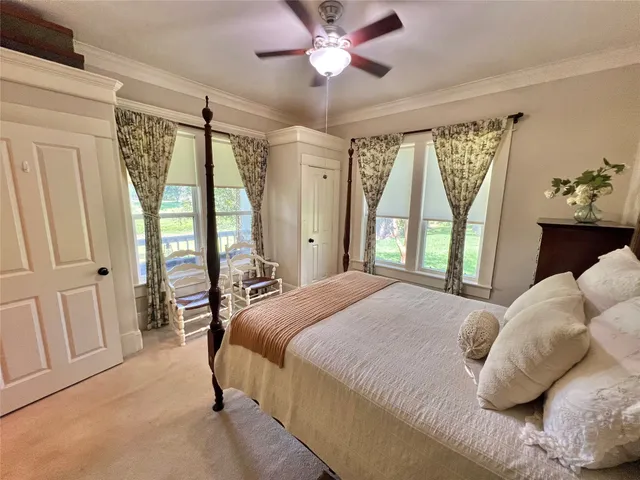 a bedroom with a large bed and a chandelier