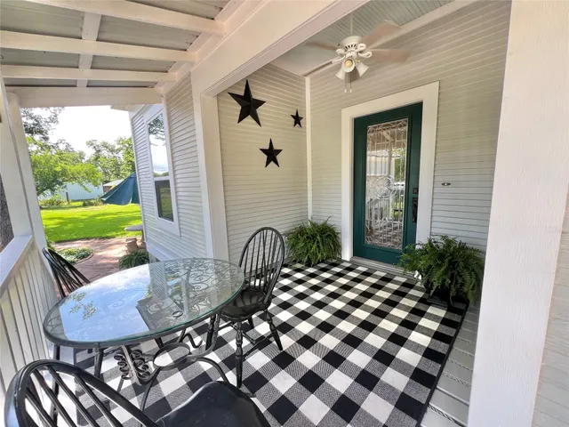 a outdoor dining space with a table and chairs