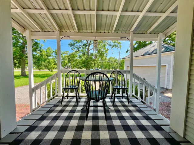 a view of a chairs and table in the patio and a garden