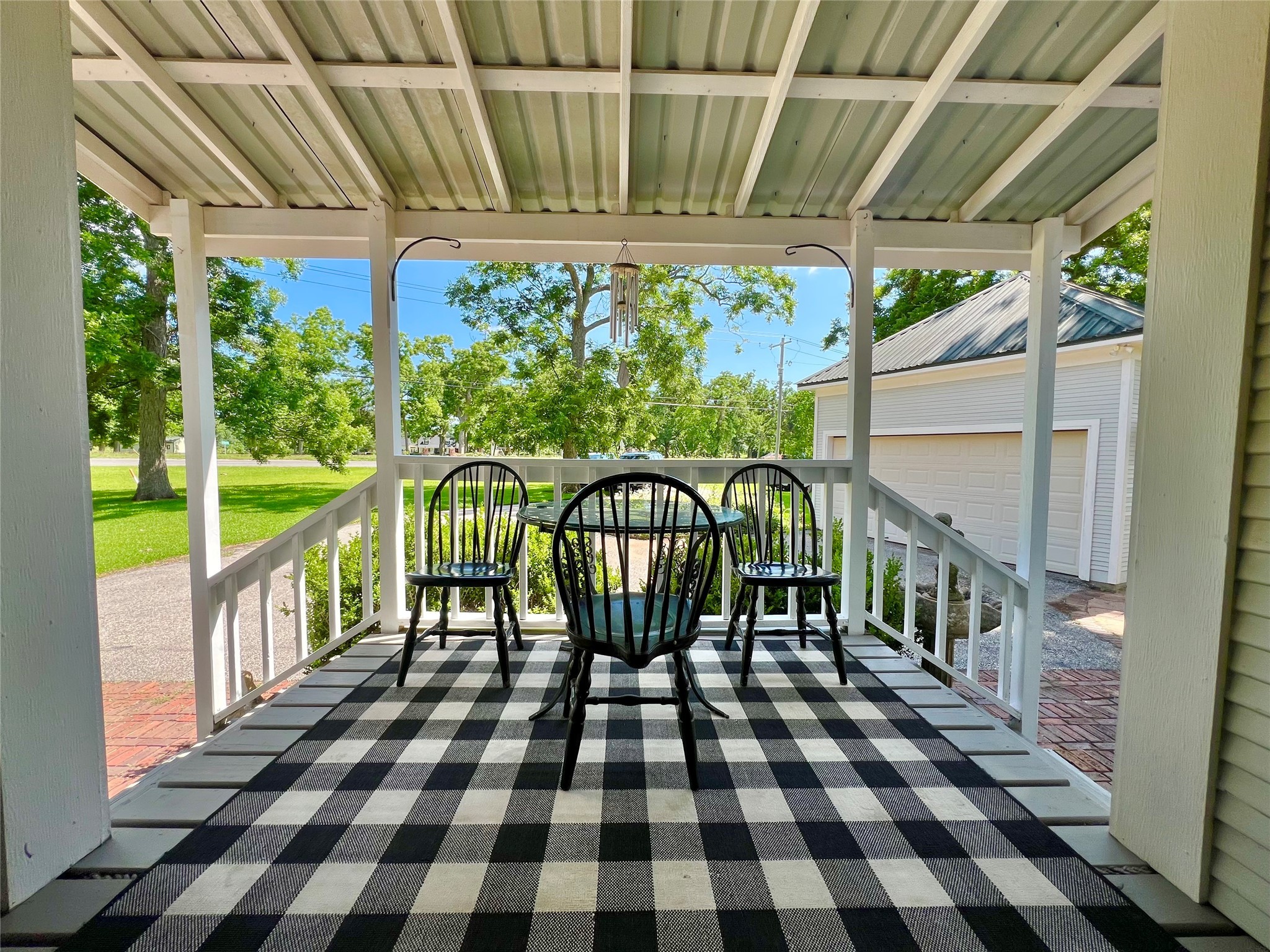 560 Jimmy Phillips Boulevard Angleton, TX 77515 - Photo 34 of 38 a view of a chairs and table in the patio and a garden