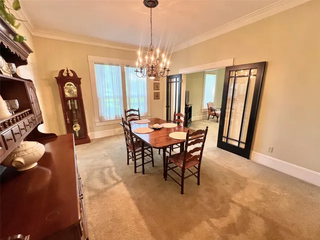 a view of a dining room with furniture and window