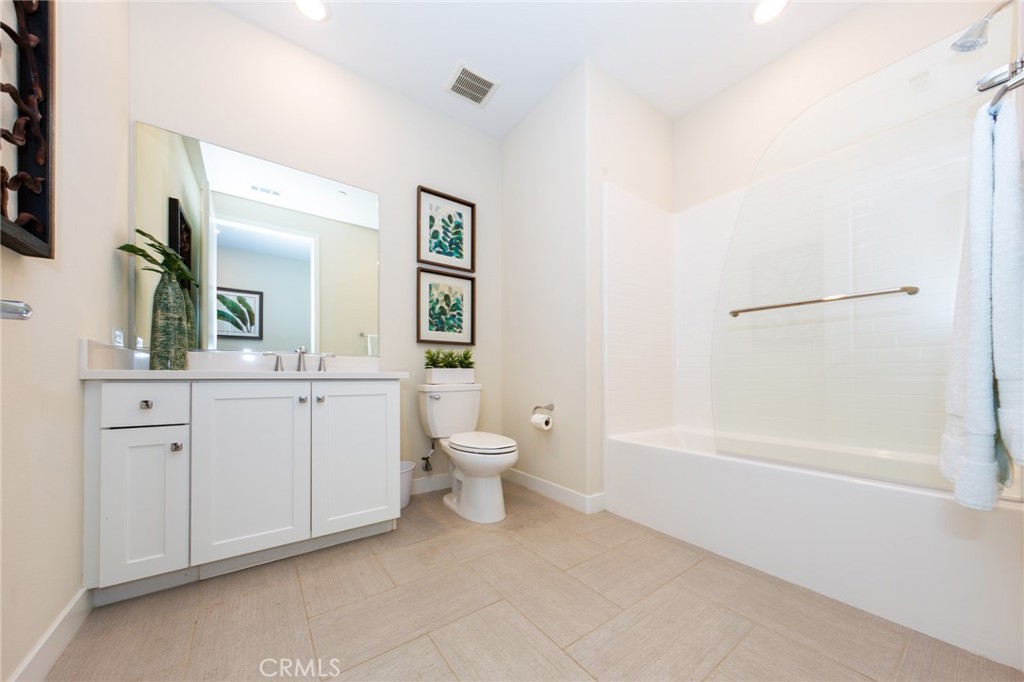 27466 Mercantile Court, Unit 101 Valencia, CA 91381 - Photo 16 of 21 a bathroom with a toilet sink and a mirror