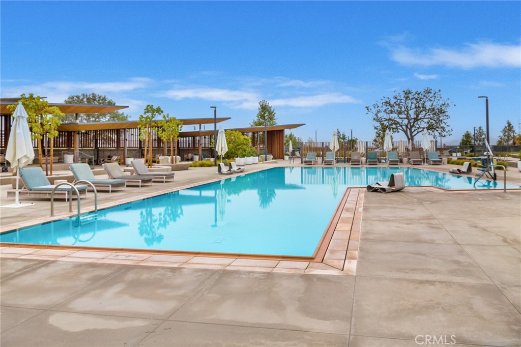 27466 Mercantile Court, Unit 101 Valencia, CA 91381 - Photo 18 of 21 a view of a swimming pool with lawn chairs