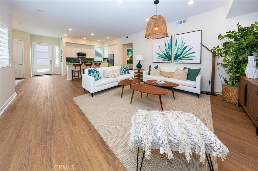 27466 Mercantile Court, Unit 101 Valencia, CA 91381 - Photo 7 of 21 a living room with furniture and a chandelier