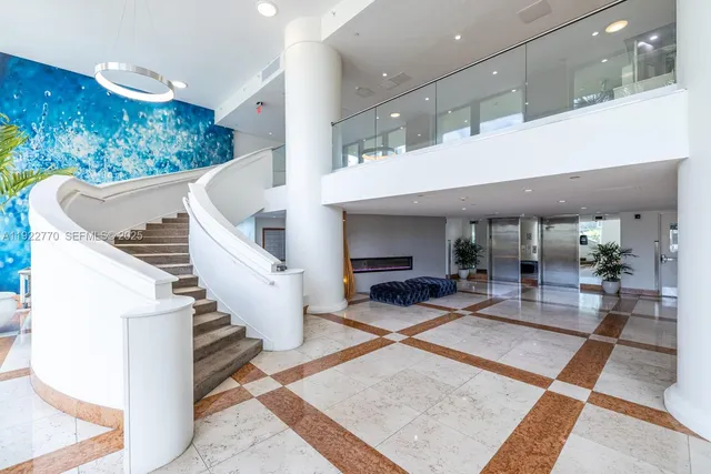 a lobby with furniture and stairs