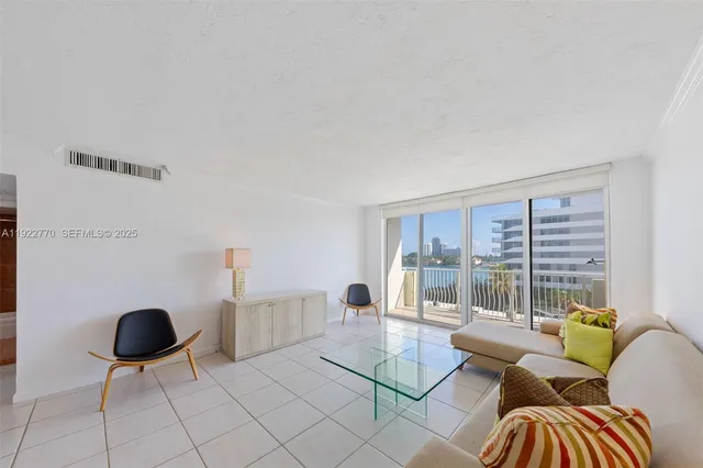 a living room with furniture and a floor to ceiling window