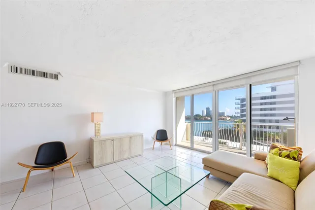a living room with furniture and a floor to ceiling window