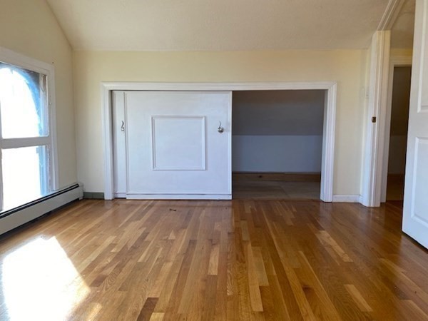 272-2 Nevada Street, Unit 2 Newton, MA 02460 - Photo 17 of 28 a view of an empty room with wooden floor and a window