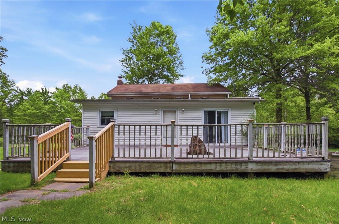 2591 Wayland Road Deerfield, OH 44411 - Photo 36 of 46 Expansive rear deck with wooden railing and steps, offering outdoor living space