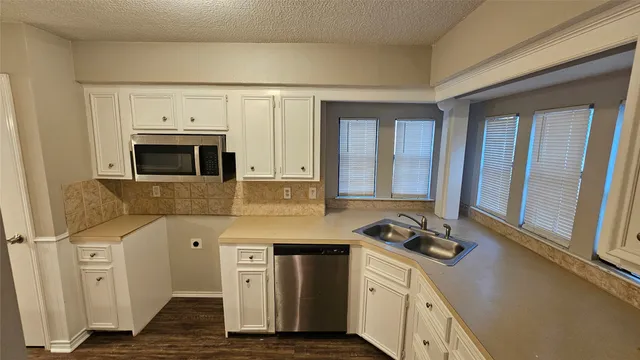 a kitchen with stainless steel appliances granite countertop a stove and a sink