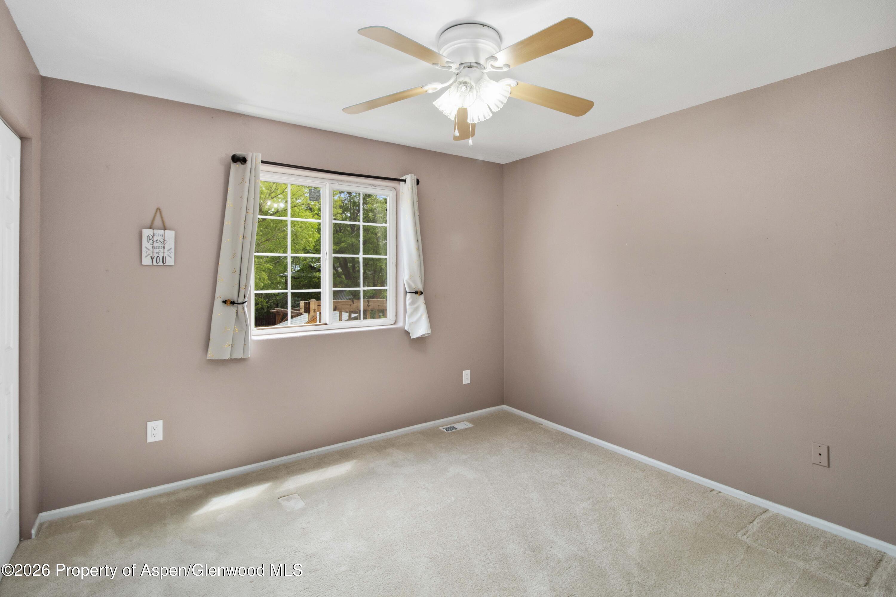 660 Aspen Avenue Rifle, CO 81650 - Photo 14 of 30 an empty room with a window and a fan