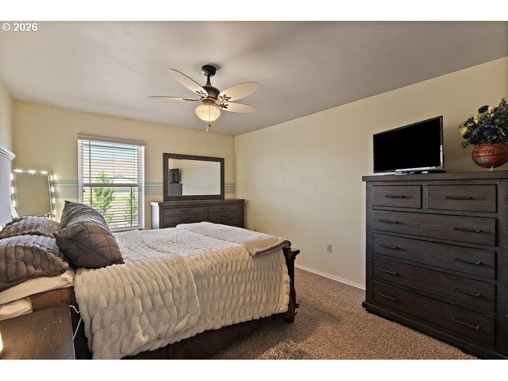 500 St Hilaire Road Yakima, WA 98901 - Photo 15 of 29 a bedroom with a large bed and a flat screen tv
