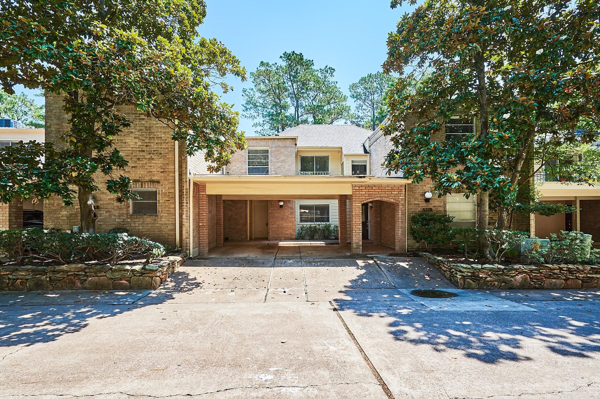 201 Vanderpool Lane, Unit 113 Houston, TX 77024 - Photo 1 of 45 a front view of a house with a yard