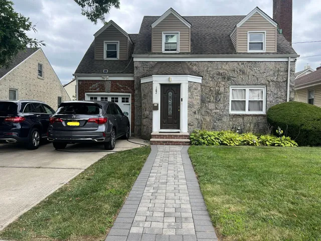 a view of a car parked in front of a brick house