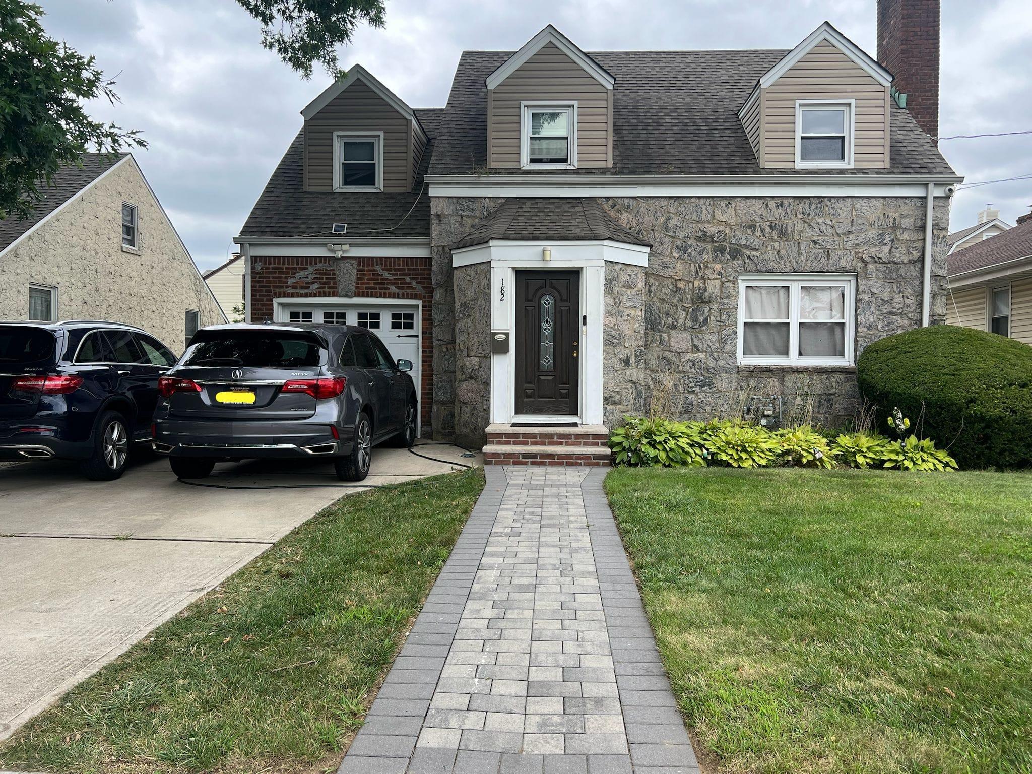 a view of a car parked in front of a brick house