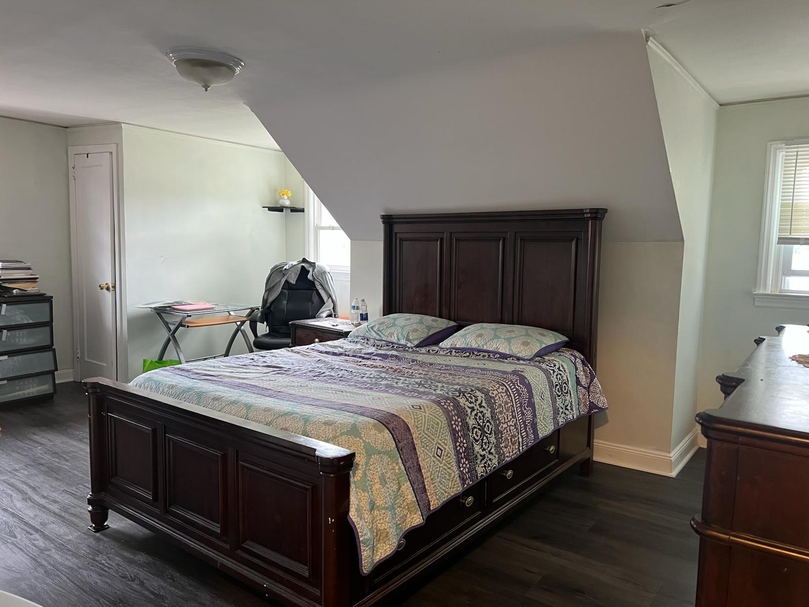 182 Long Beach Road Hempstead, NY 11550 - Photo 12 of 24 a bedroom with a bed and wooden floor