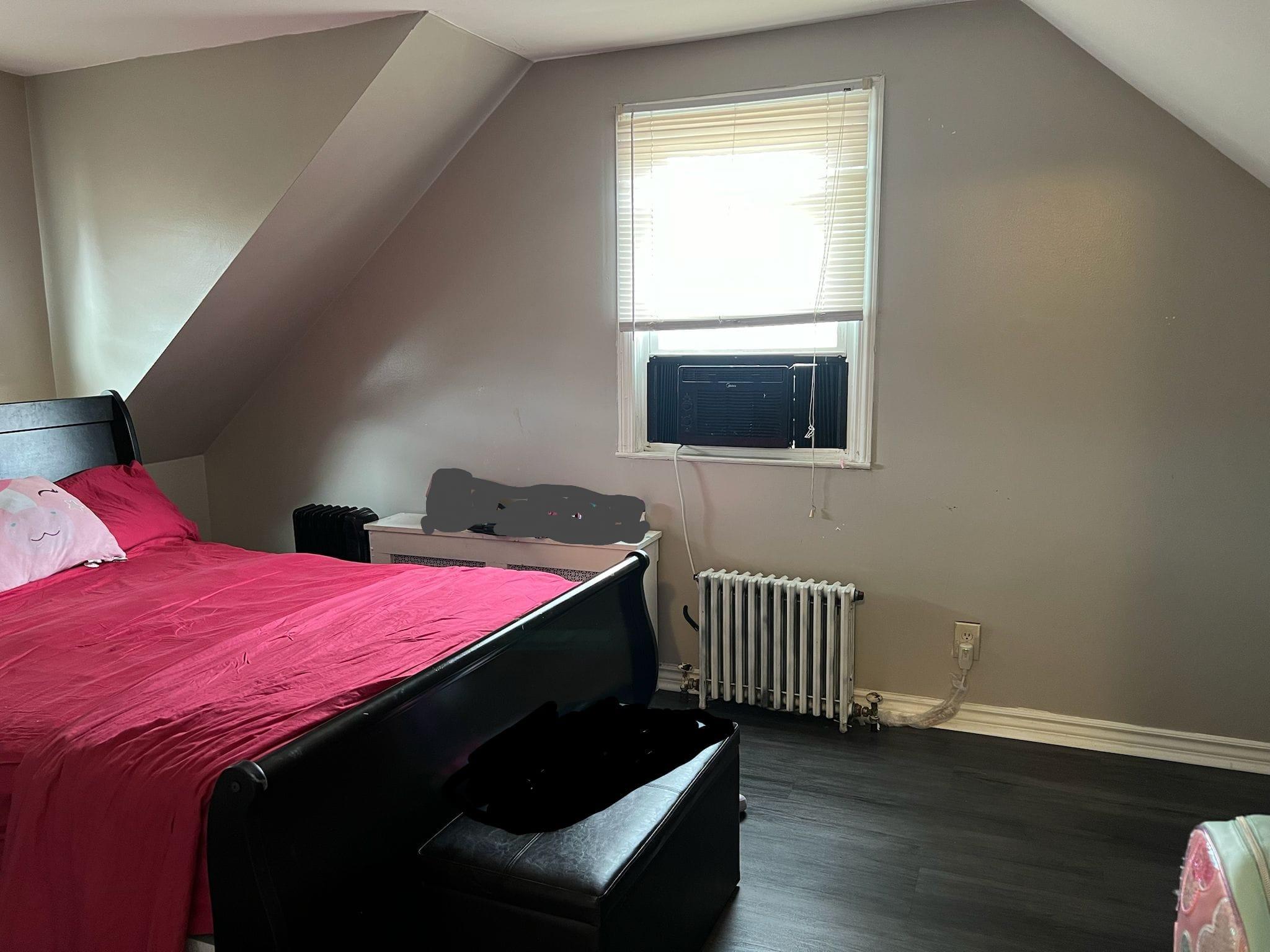 182 Long Beach Road Hempstead, NY 11550 - Photo 14 of 24 a bedroom with a bed and wooden floor