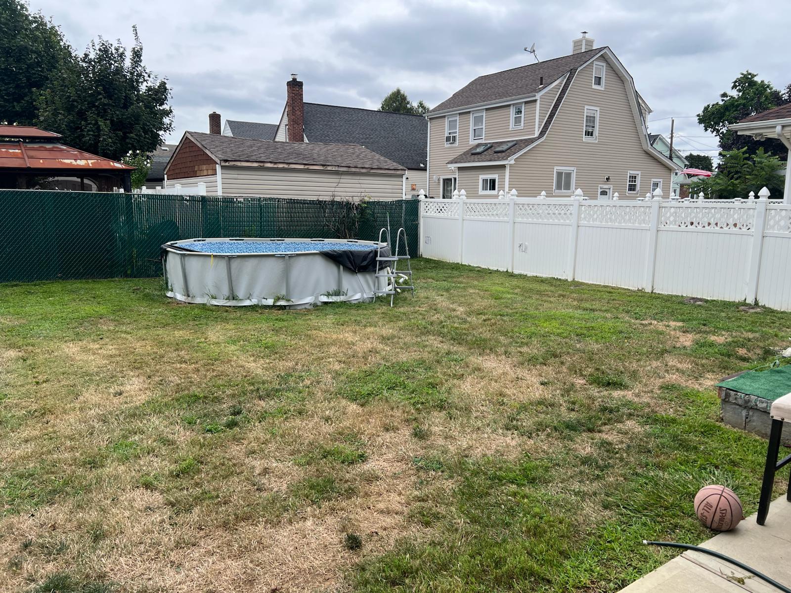 182 Long Beach Road Hempstead, NY 11550 - Photo 19 of 24 a front view of a house with a yard and garage