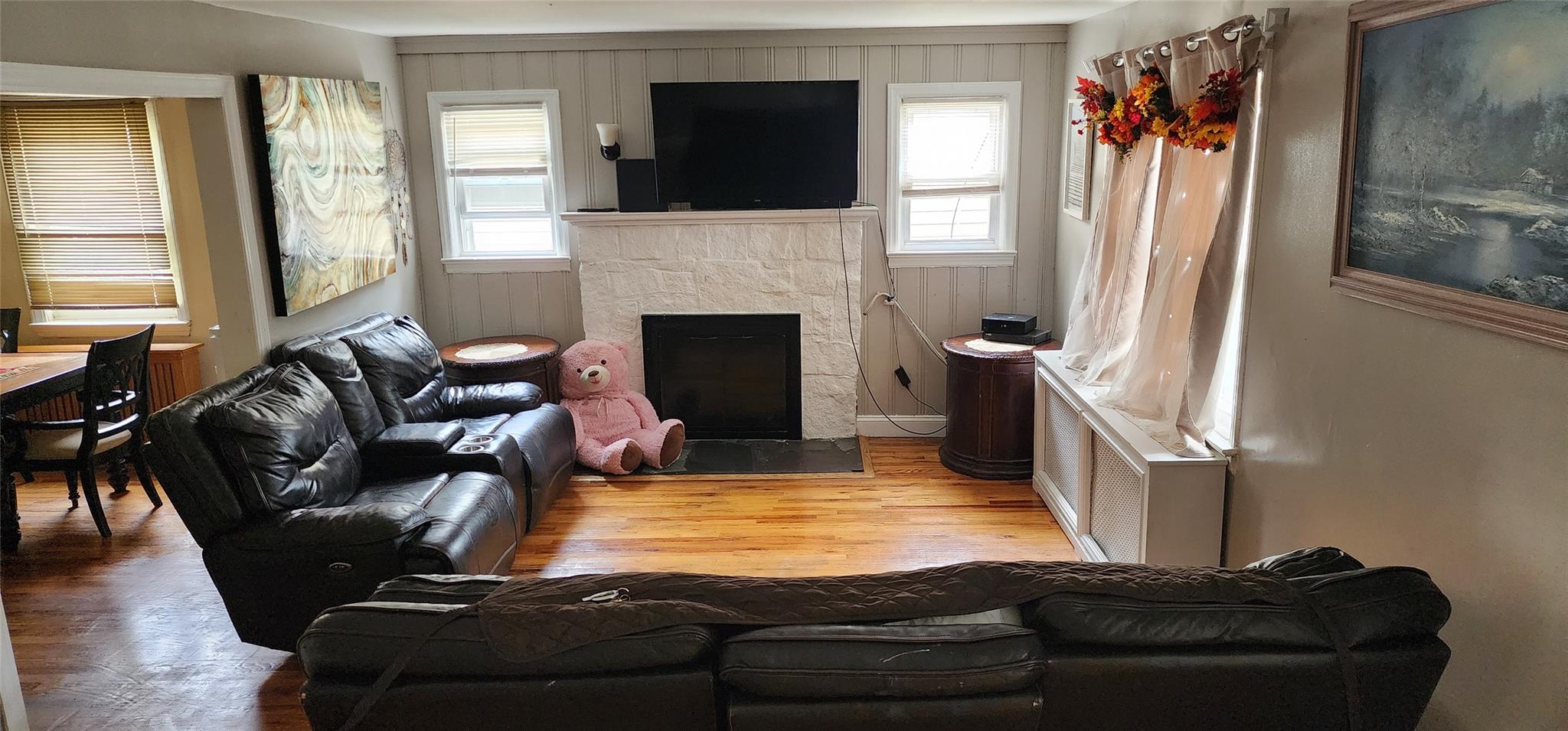 182 Long Beach Road Hempstead, NY 11550 - Photo 5 of 24 a living room with furniture fireplace and flat screen tv