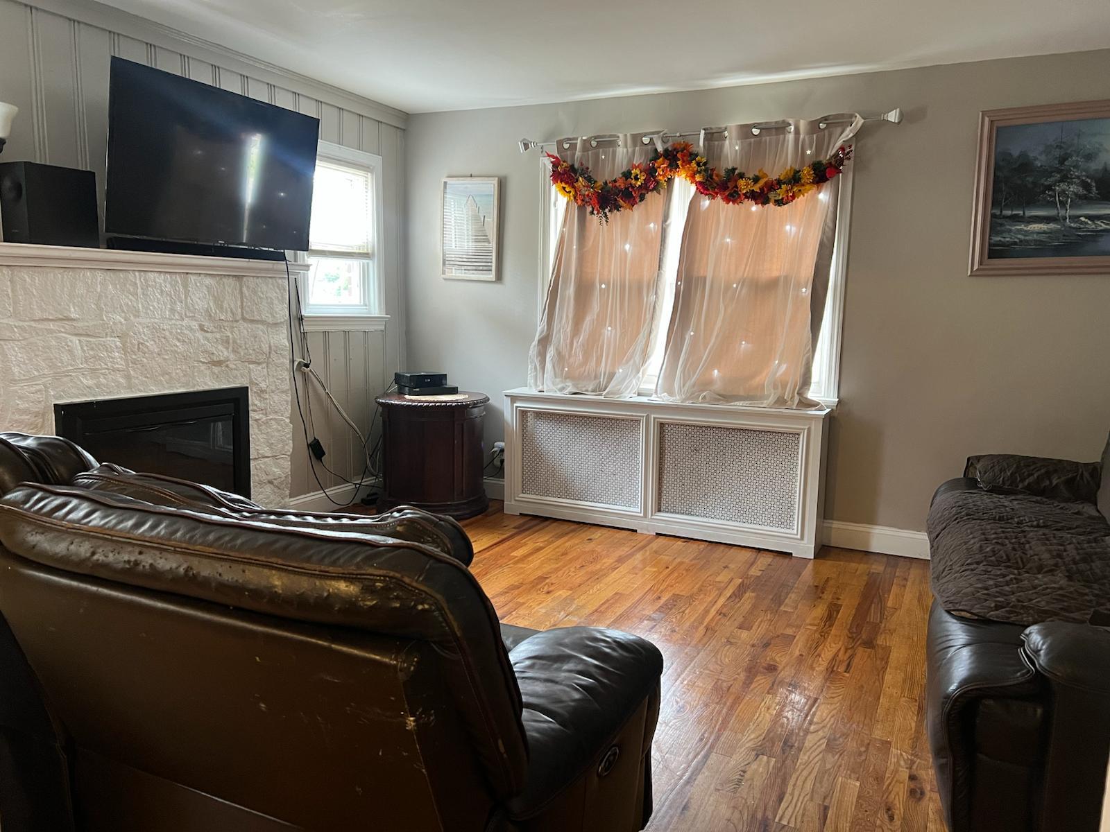182 Long Beach Road Hempstead, NY 11550 - Photo 6 of 24 a living room with furniture and a fireplace