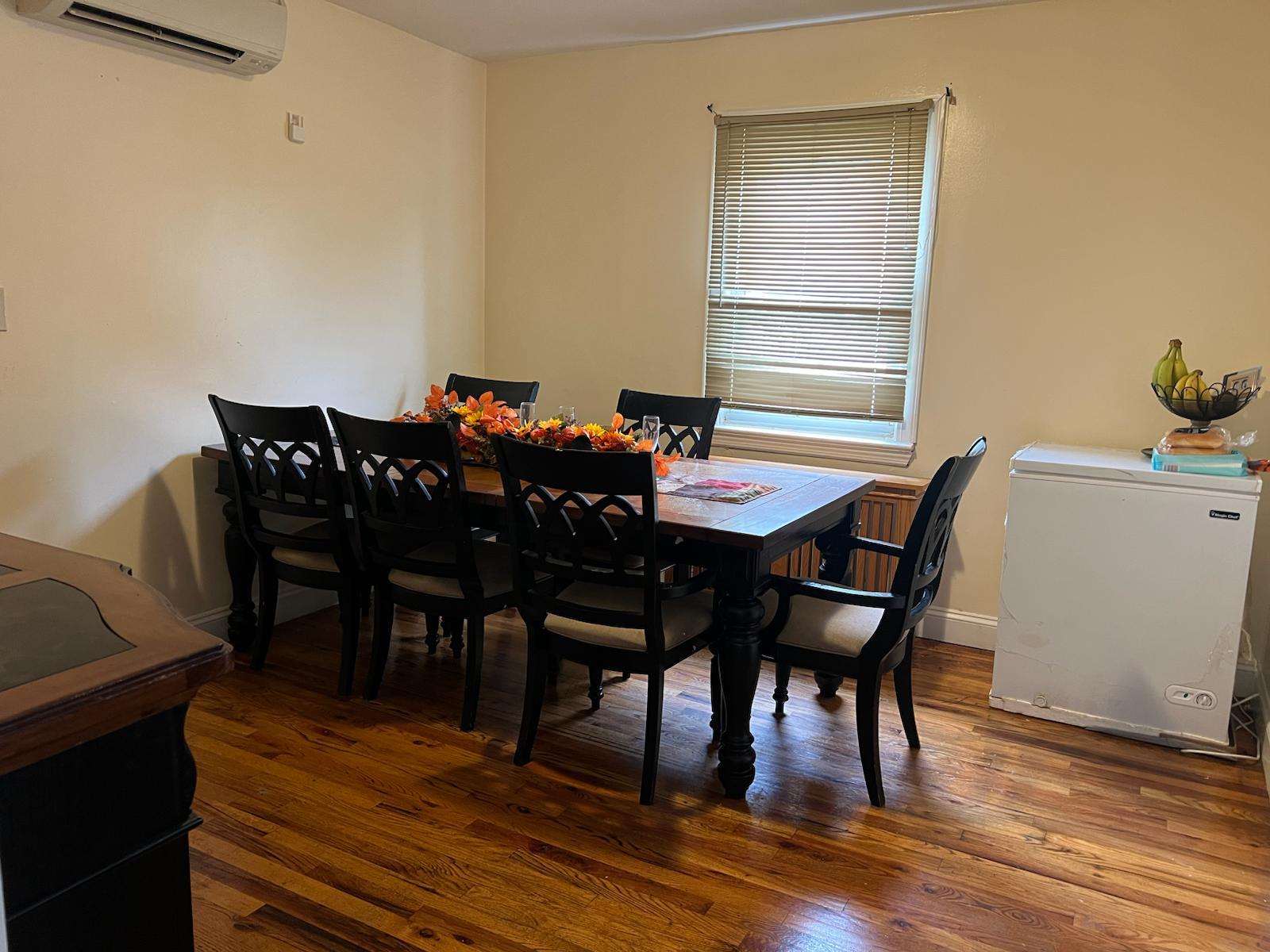 182 Long Beach Road Hempstead, NY 11550 - Photo 7 of 24 a view of a dining room with furniture and wooden floor
