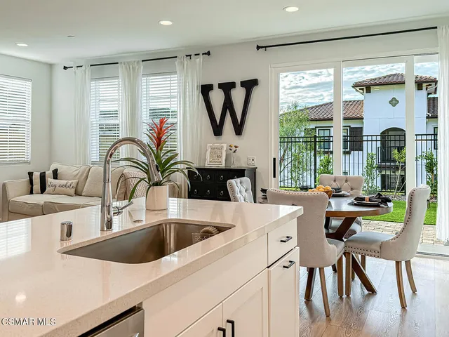 a view of a house with pool and chairs