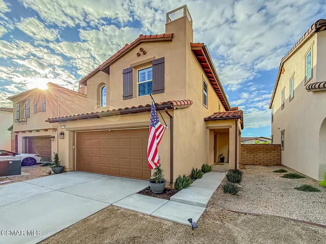 a kitchen with a sink appliances and a large window
