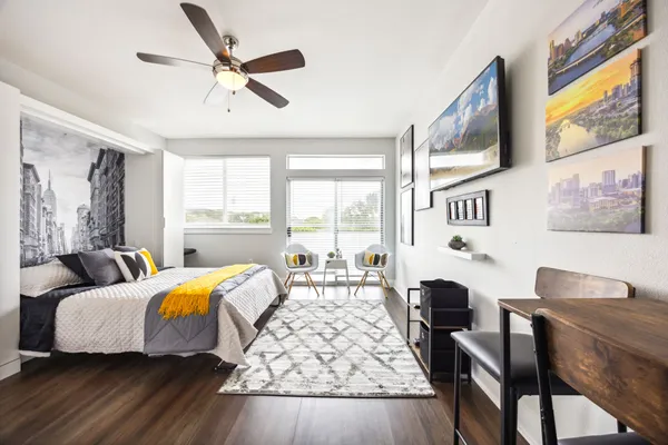 a bedroom with two beds and a large window