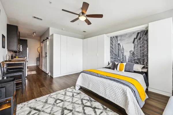 a bedroom with a bed and a chandelier